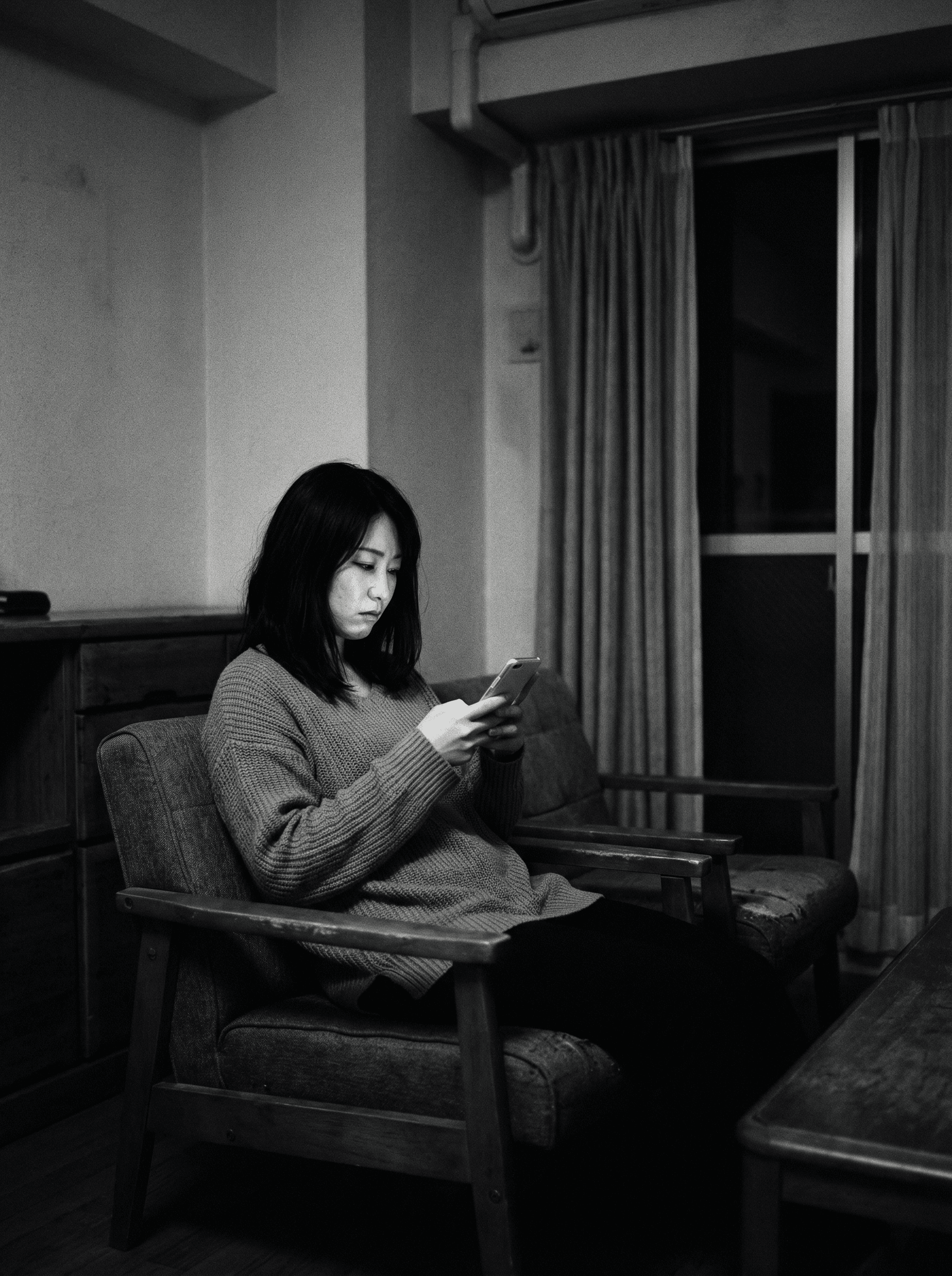 迷路の中にいるような抽象的なイラスト、または暗い部屋でスマホを見つめる女性のモノクロ写真。